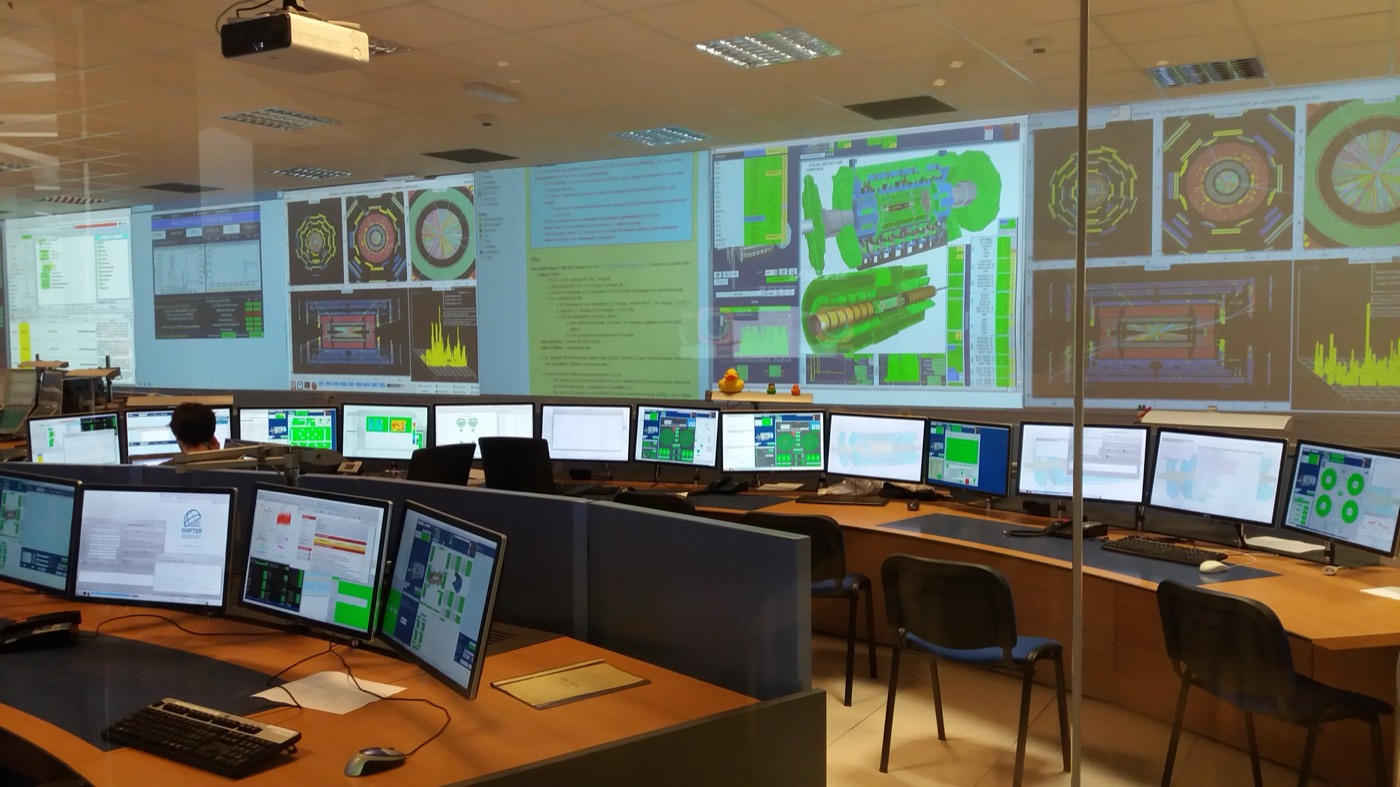 ATLAS experiment control room with projected system diagrams